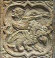 Panel 18:01 - Man/basilisk hybrid (?) blowing horn (partly eroded)